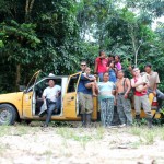 All of the Raft Amazonia family smiling for the camera in front of Luis's taxi.