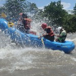 A group of travellers tackle a rapid in their raft on the Amazon river.