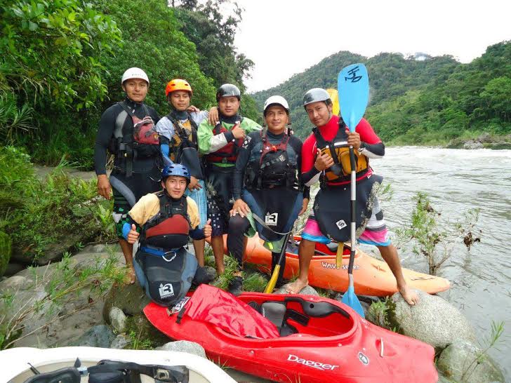 Six experienced local guides by the Amazon river in their safety gear with their kayaks.