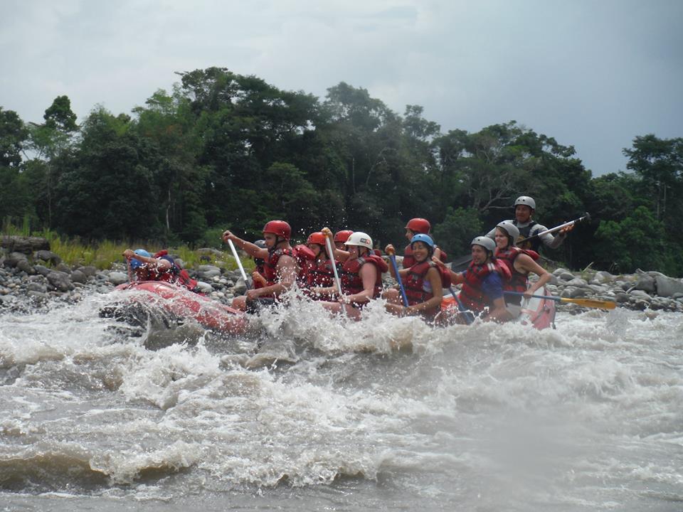 A group on a white water rafting tour on the Amazon river.